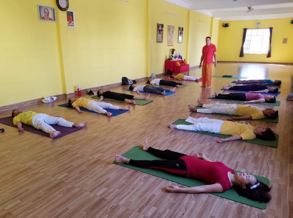 Mọi người đều đang tập trung tập yoga theo hướng dẫn. Ảnh SivaDevi yoga - SYAC 
